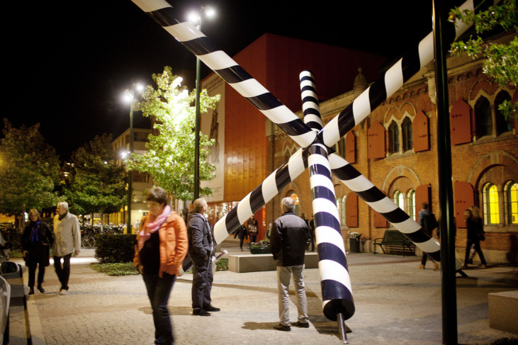 Exterior of Moderna Museet Malmö with woman standing next to sculpture