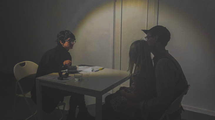 Three people sitting at table.