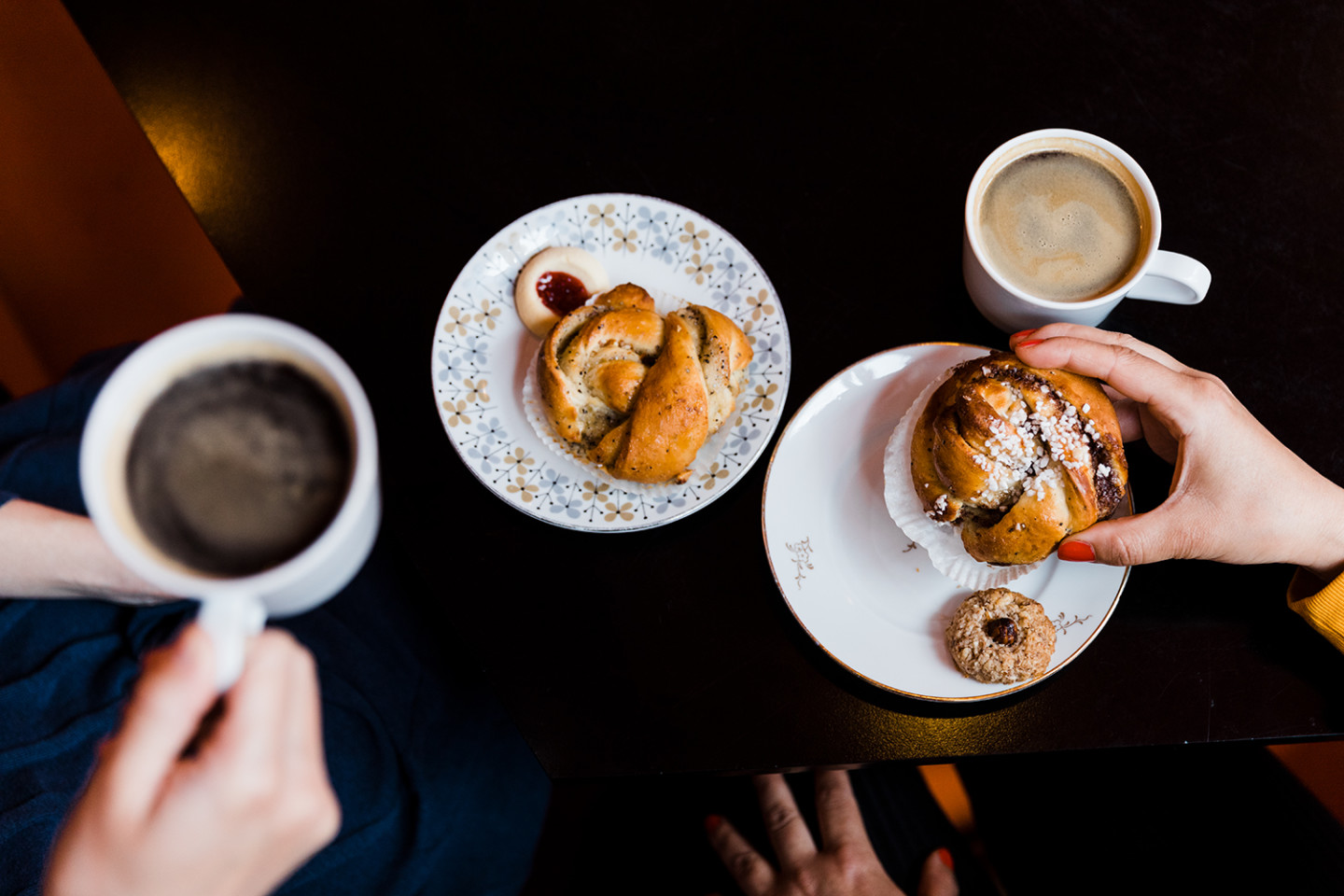 Table with coffeecup and cinnamon buns.