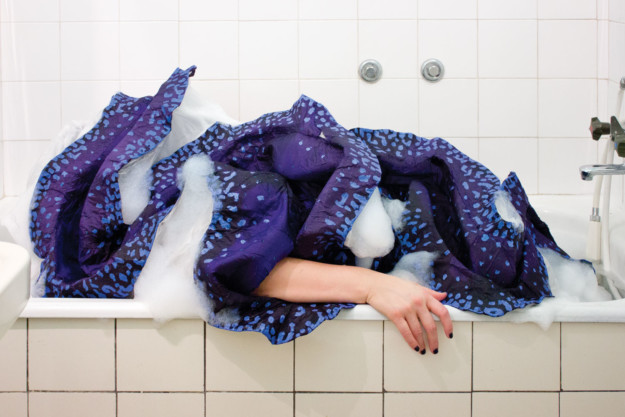 Bath tub with creature and arm resting on the side.