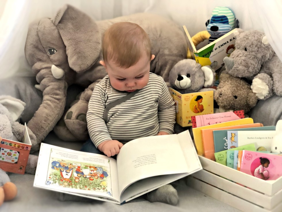 Baby sitting with book in lap