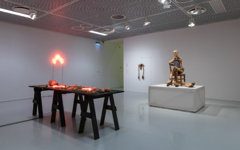 Photo of exhibition room with wooden sculptures