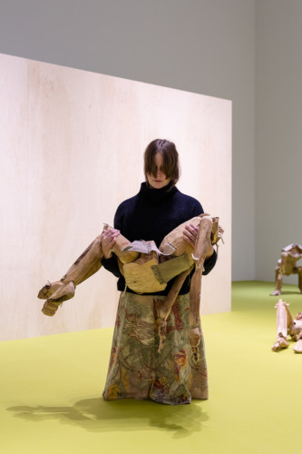 Photo of woman holding wooden doll
