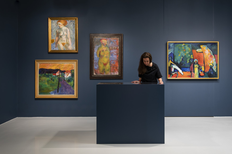 Woman in exhibition room looking at artwork