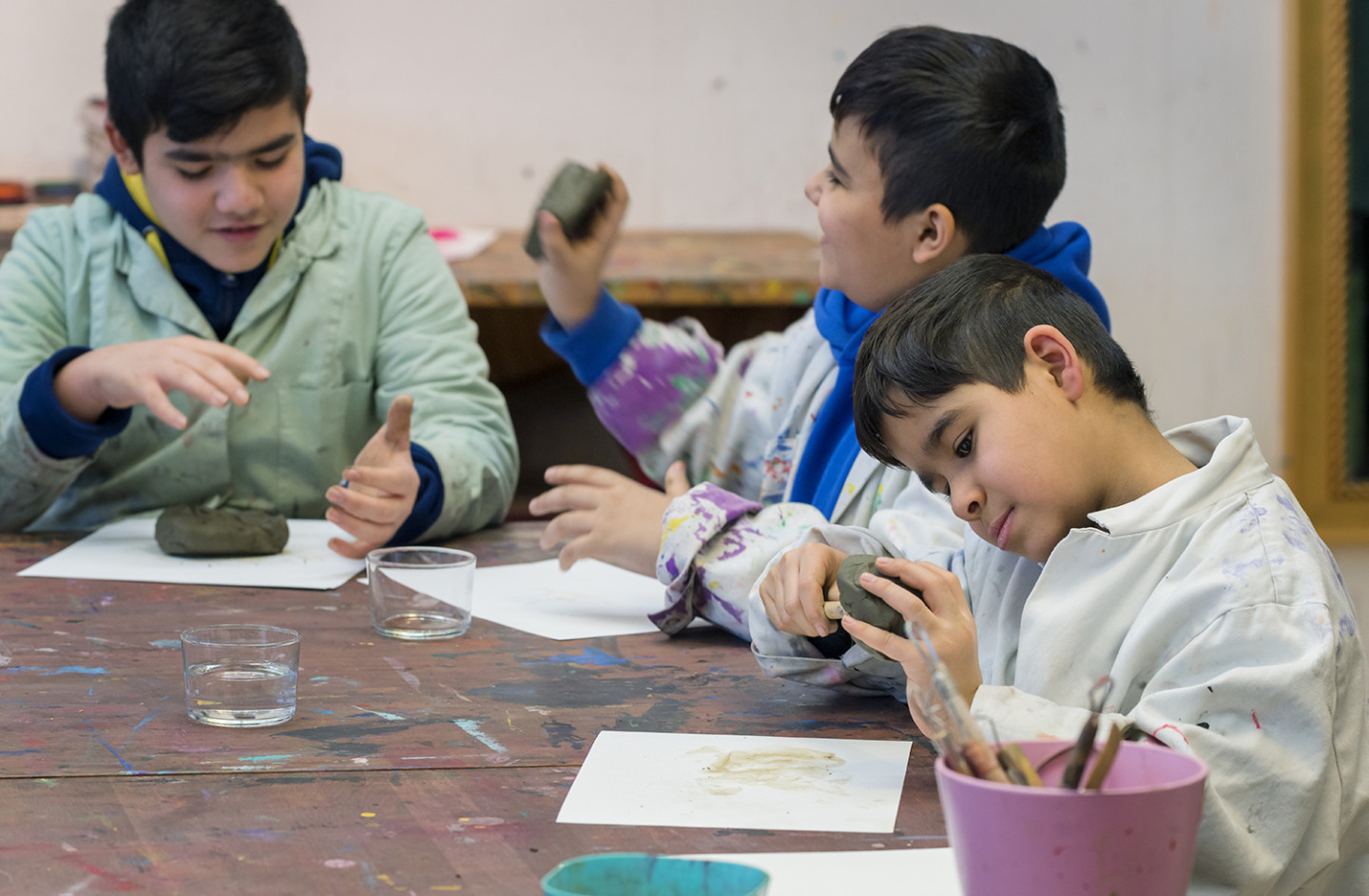 Three children creating in the workshop