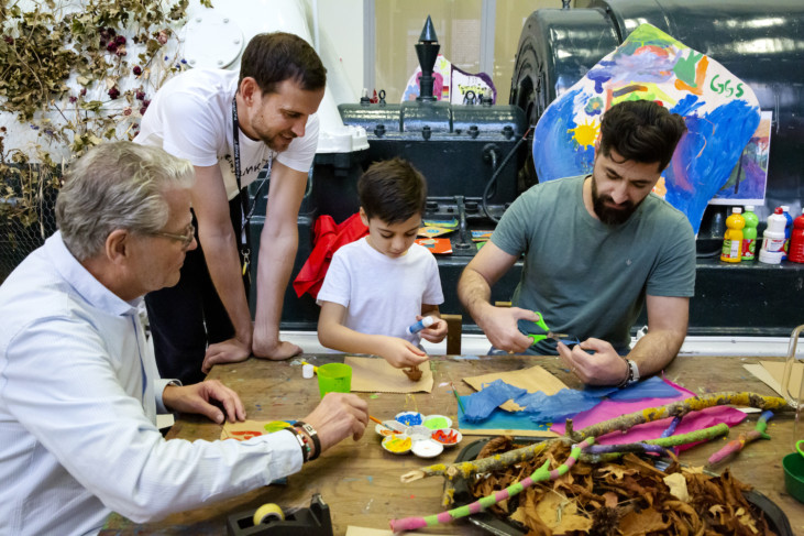 Four people creating together in workshop