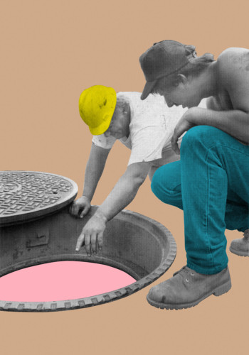 Photo with two persons looking down in hole