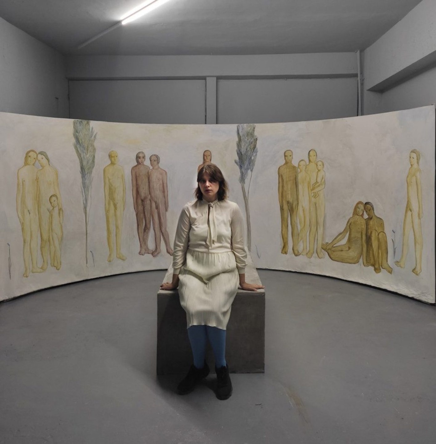 sitting woman surrounded of drawings