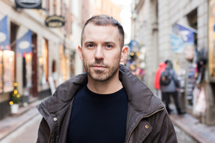 photo of man facing us with street in background