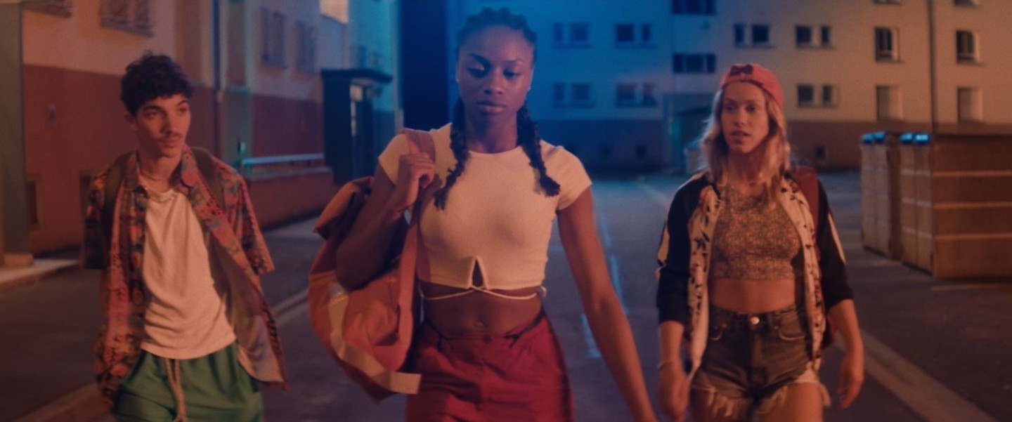 three young people walking gon street