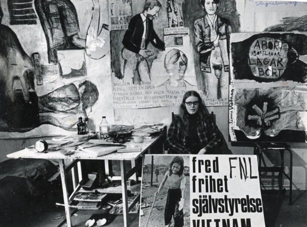 woman sitting in studio with pictures around her