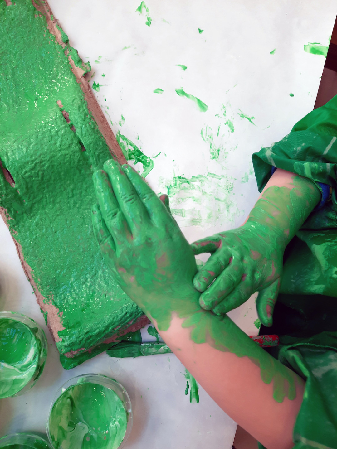 hands full of green paint