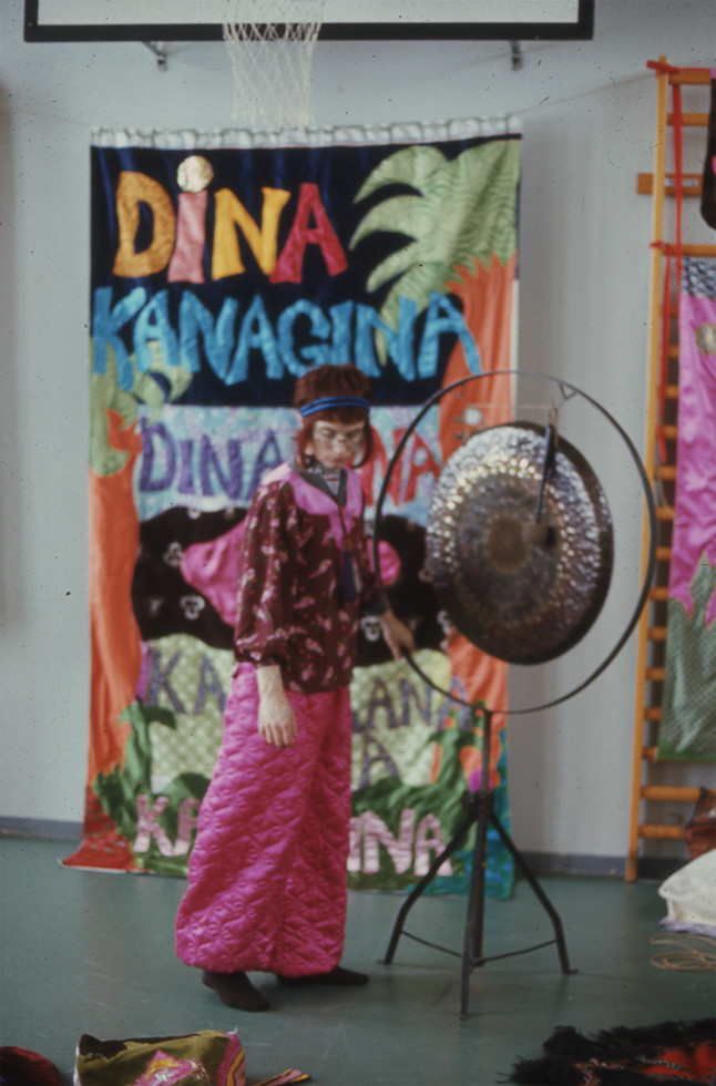 photo of woman standing with big gong