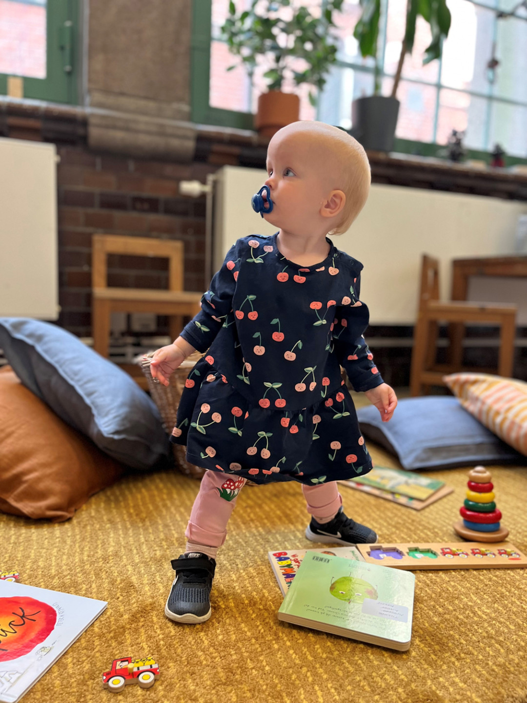 photo of small child with toys and books