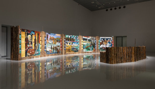 installation with artwork of paintings and wood