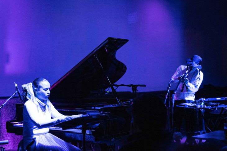 photo in blue tones of two musicians playing