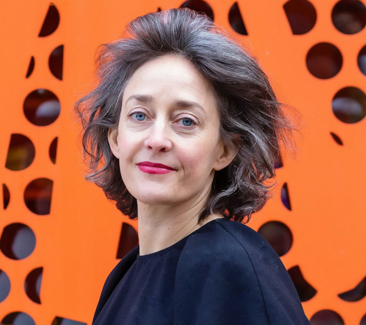 photo of standing woman with orange background