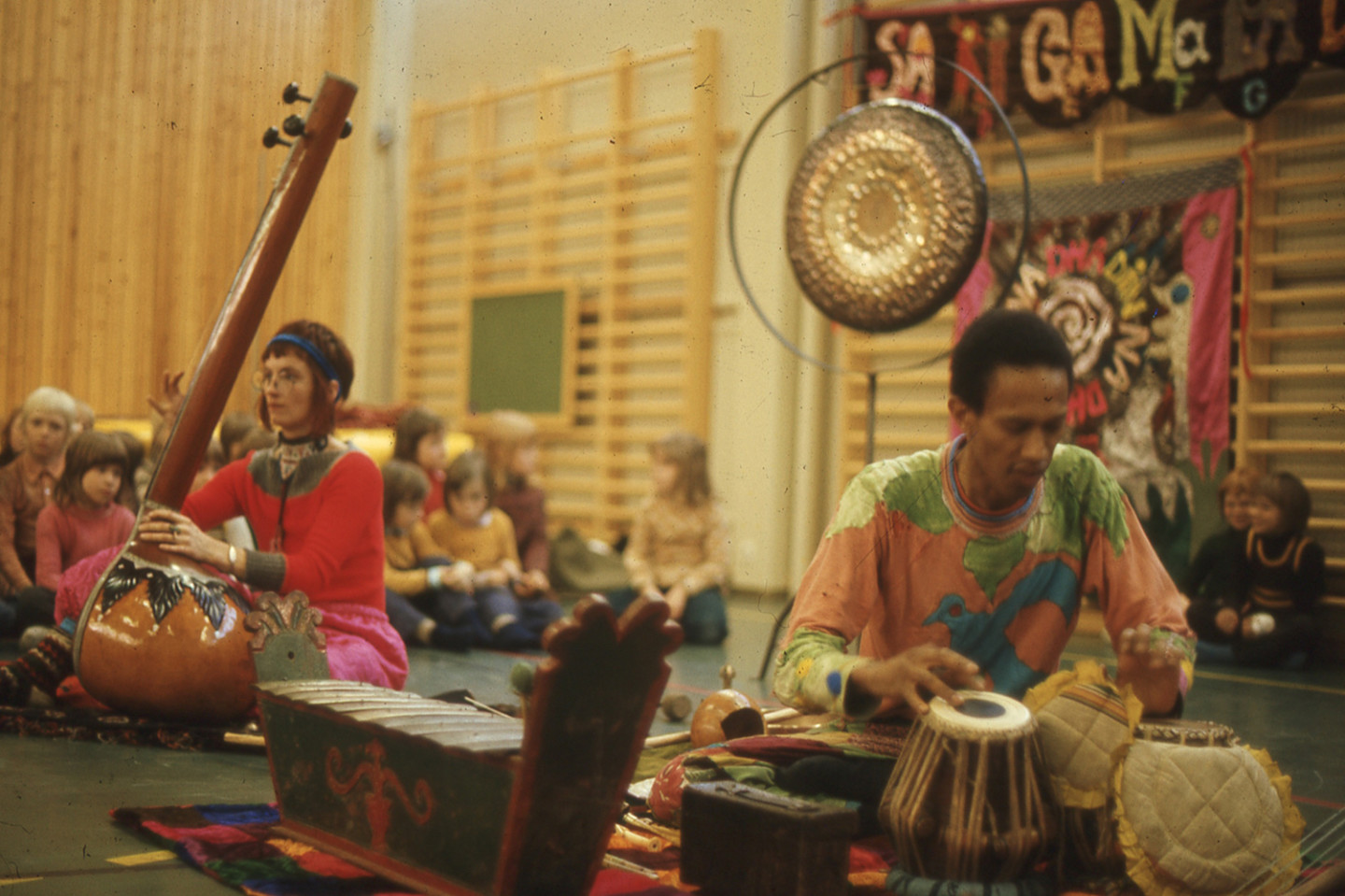 two persons playing instruments in a school