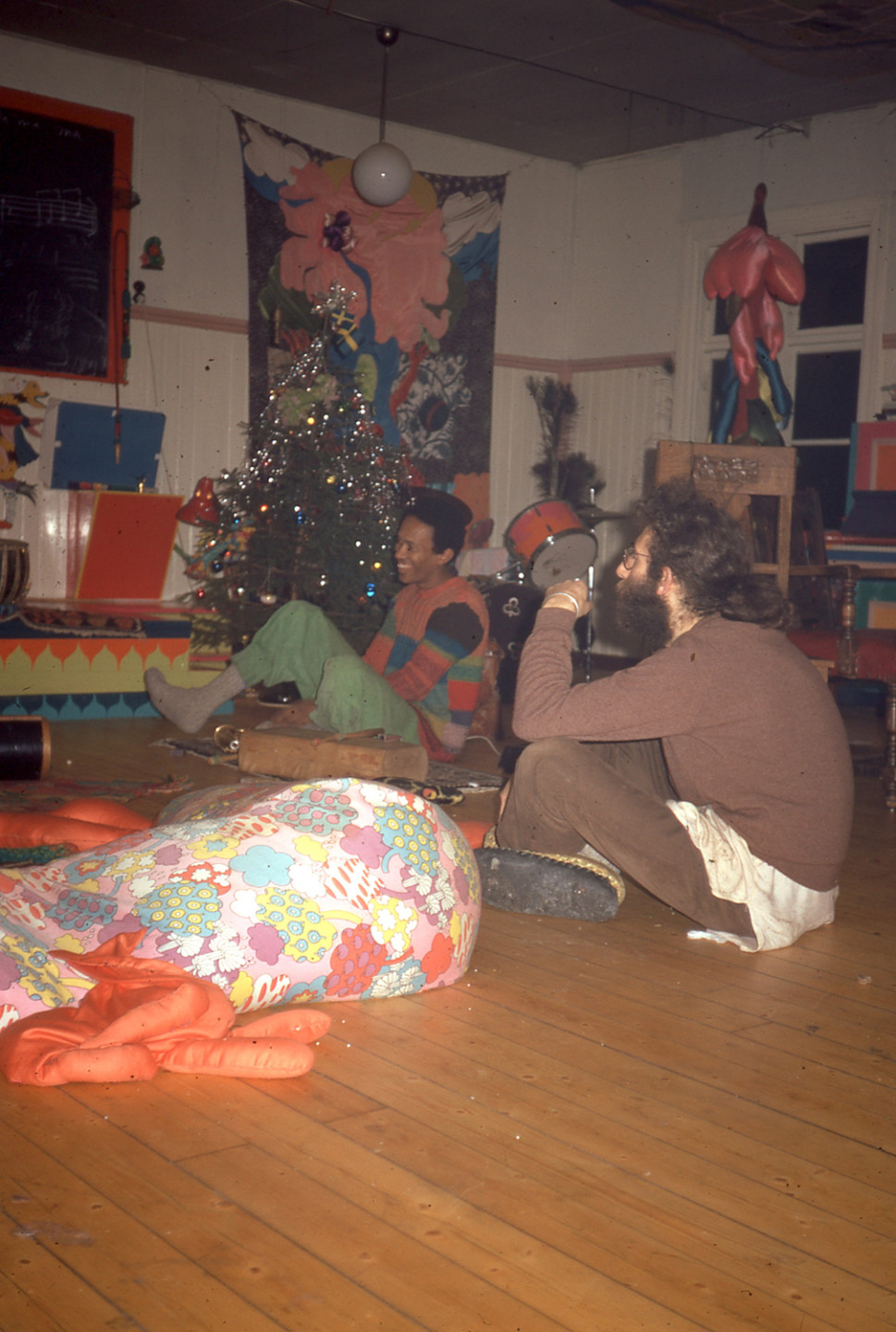 two men in a room sitting on floor