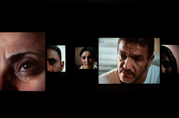 still from video with five faces