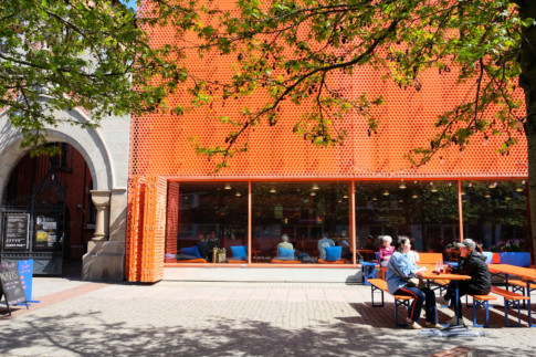 photo of exterior with people having coffee