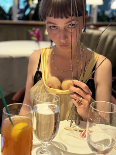young woman sitting at table with glasses