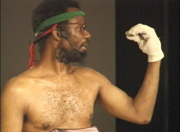 man in profile making gesture with his hand