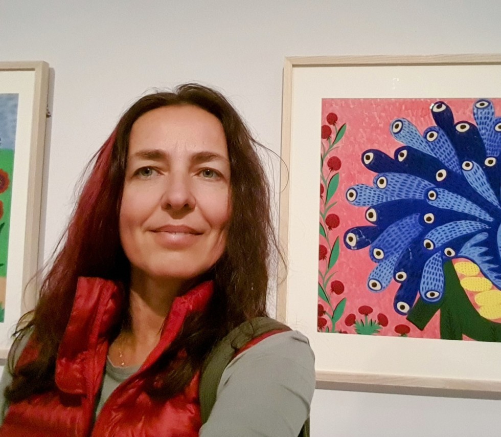photo of woman with painting behind her