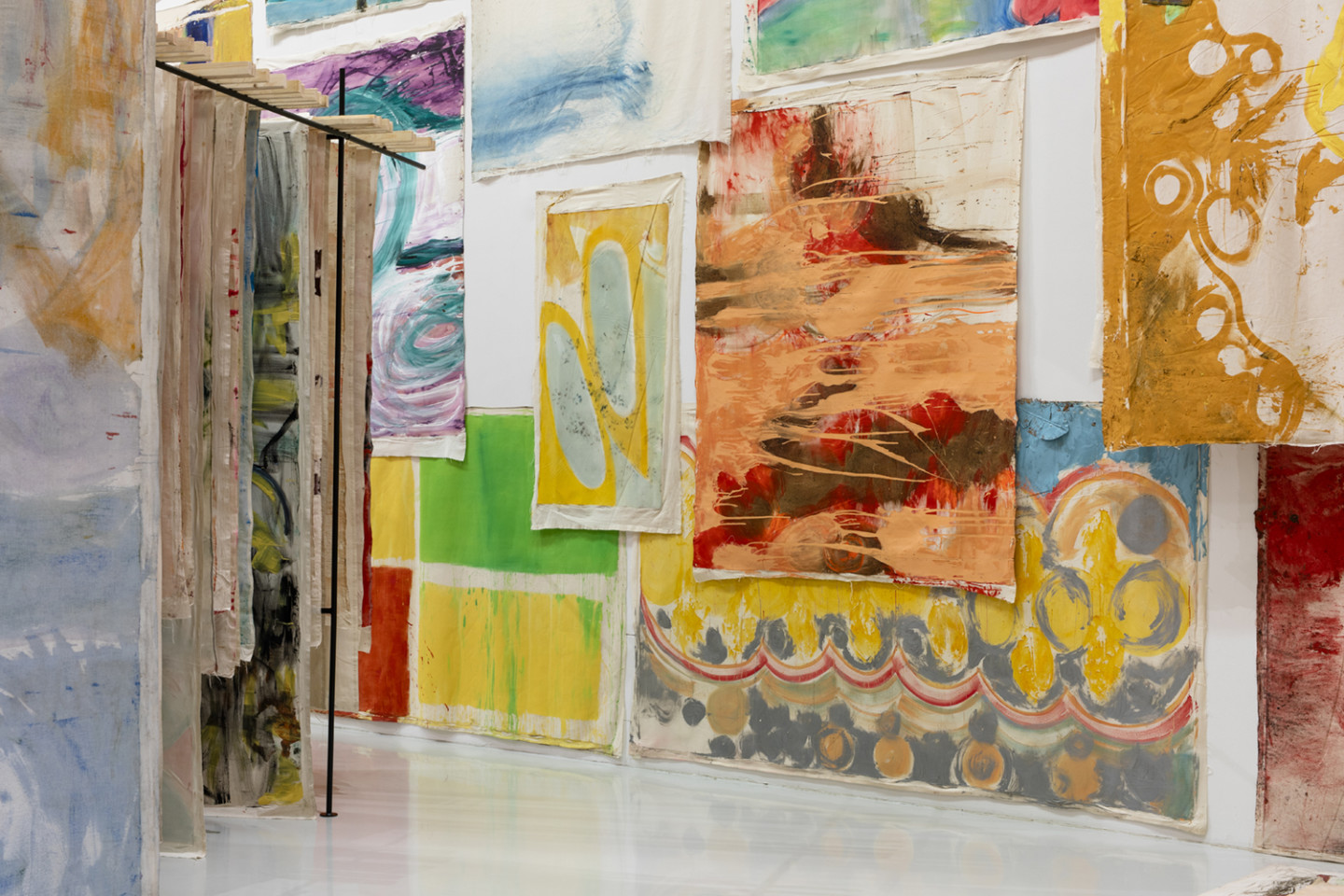 installation view with paintings hanging overlapped