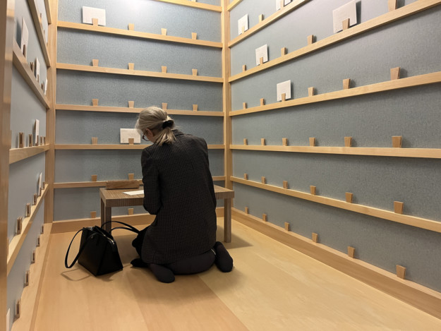 woman sitting on floor at small table