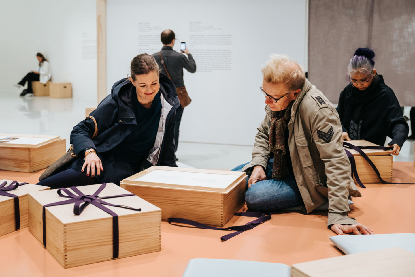 sitting persons looking in a box 