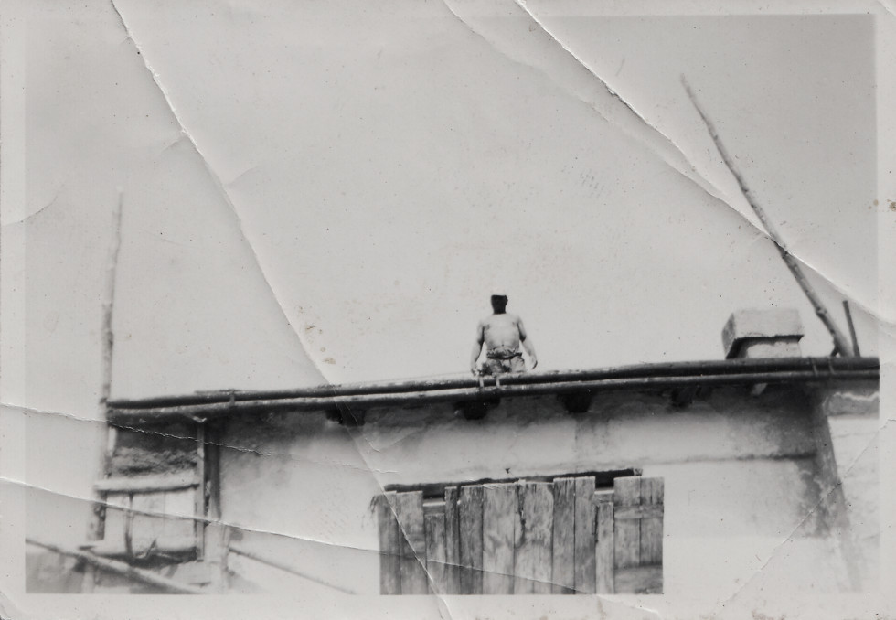 Photography of a man standing on a building.