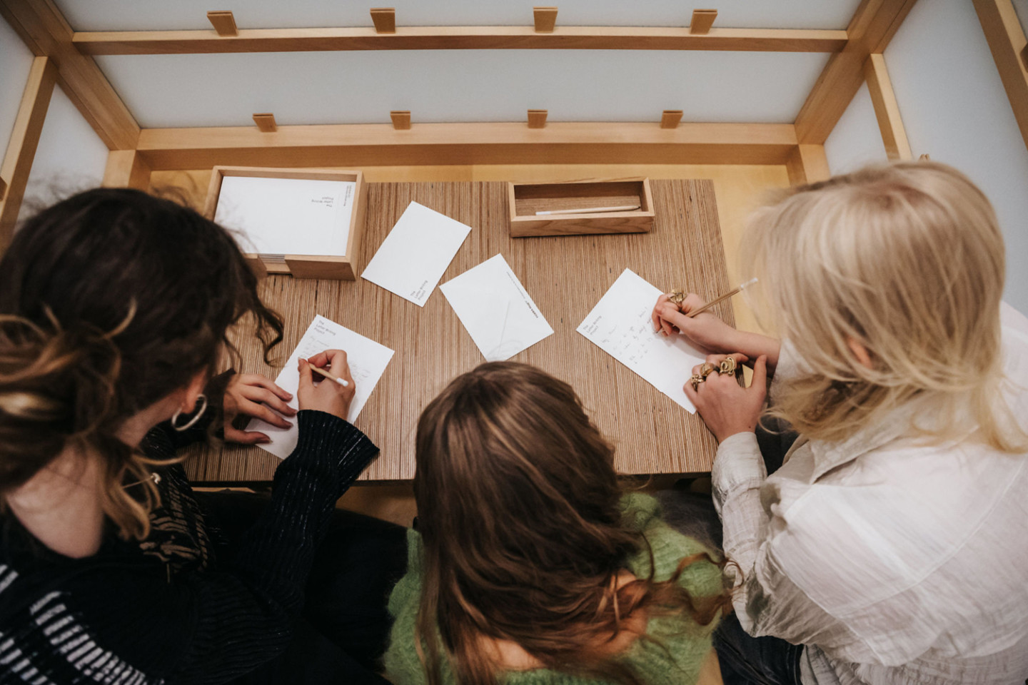 three persons writing letters