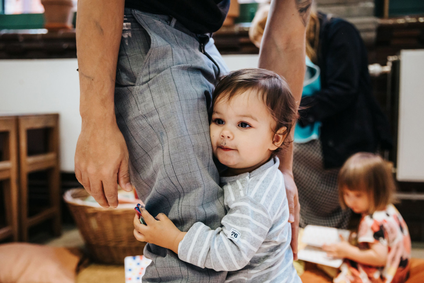 child hugging leg