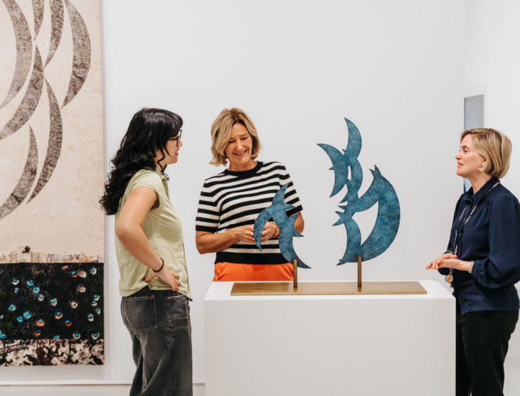 three persons in exhibition
