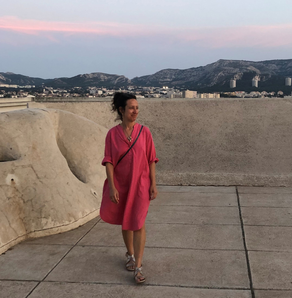 photo of walking woman in red dress