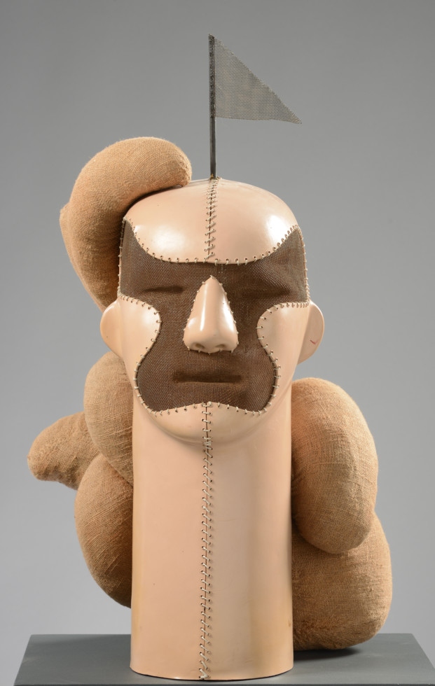 sculpture of man's head with flag on top