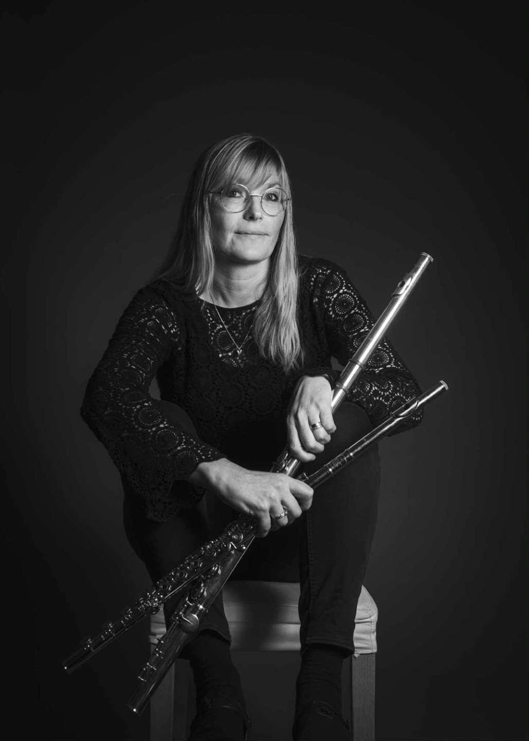 sitting  woman with flutes in hand 