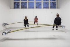 Three people sitting on boards