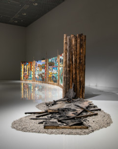 installation view with artwork of wood and paintings