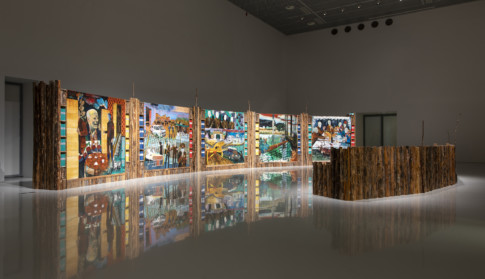installation view of artwork made of wood and paintings