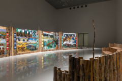 installation view with artwork made of wood and paintings