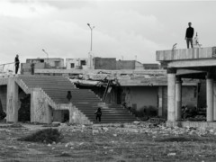 black and white photo with building and stairs and persons