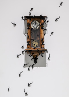 photo of wall clock with creatures all over