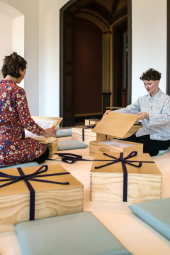 two people sitting in room with boxes