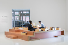 Two people opening boxes