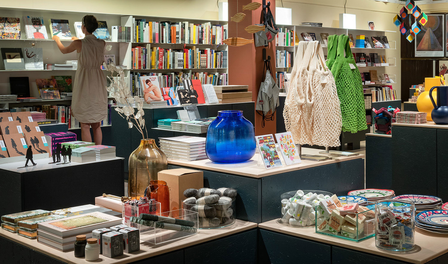 The shop interior, with bookshelves and tables with products.