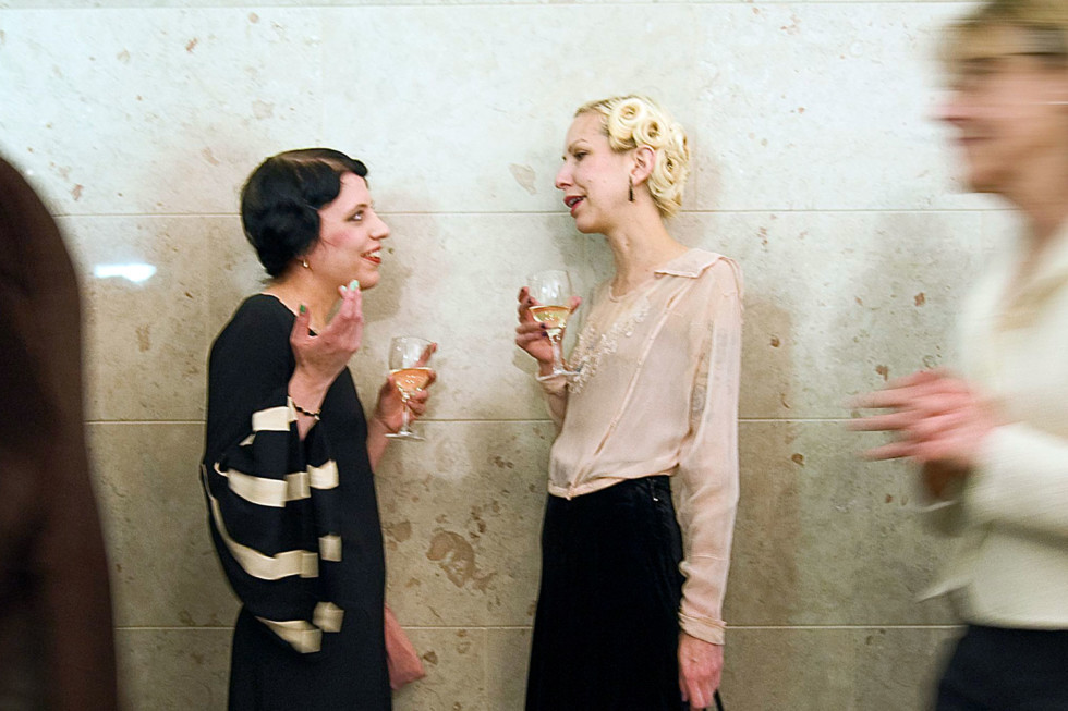 Two women talking, dressed for party
