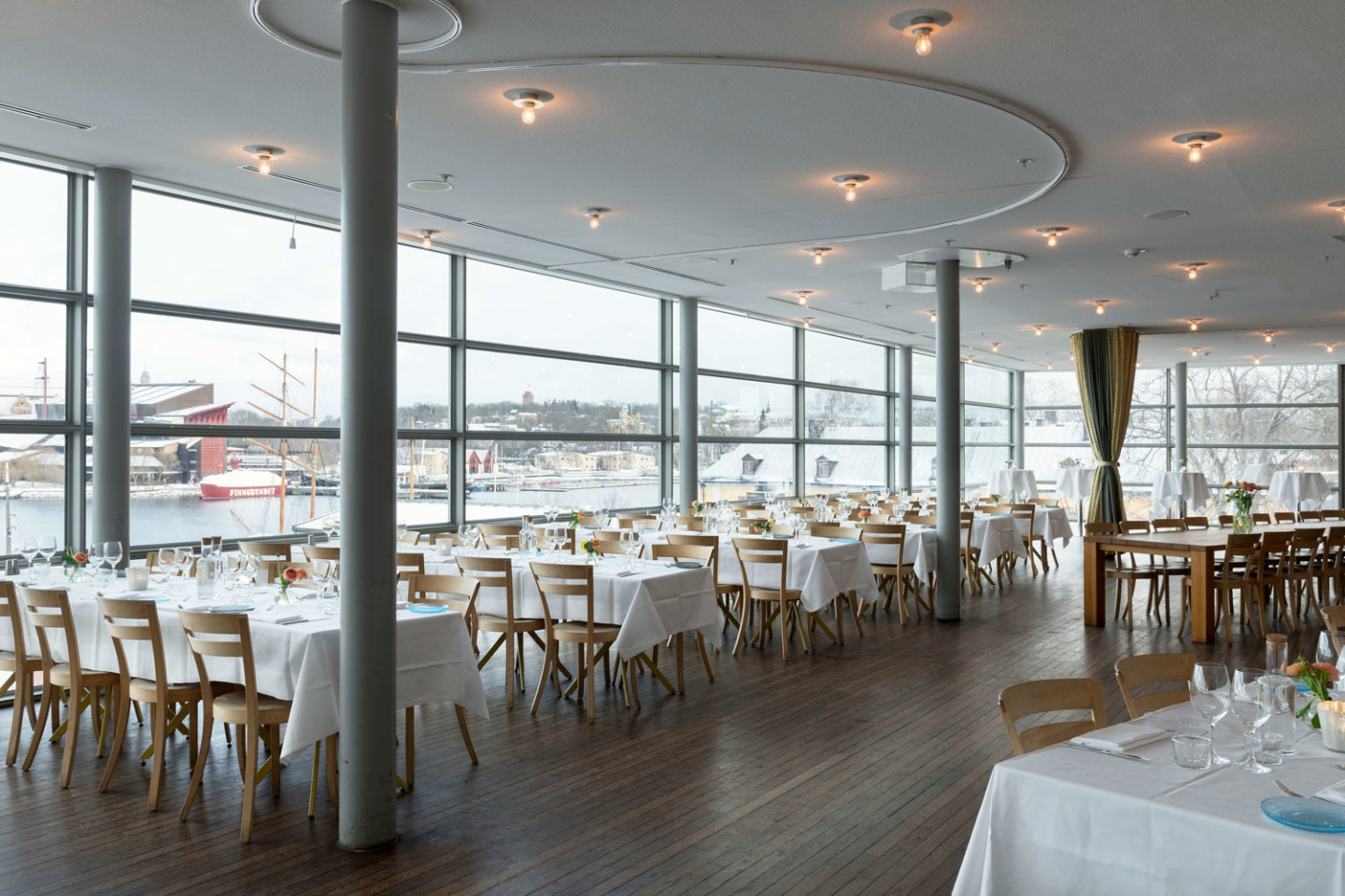 Tables set in bright room.