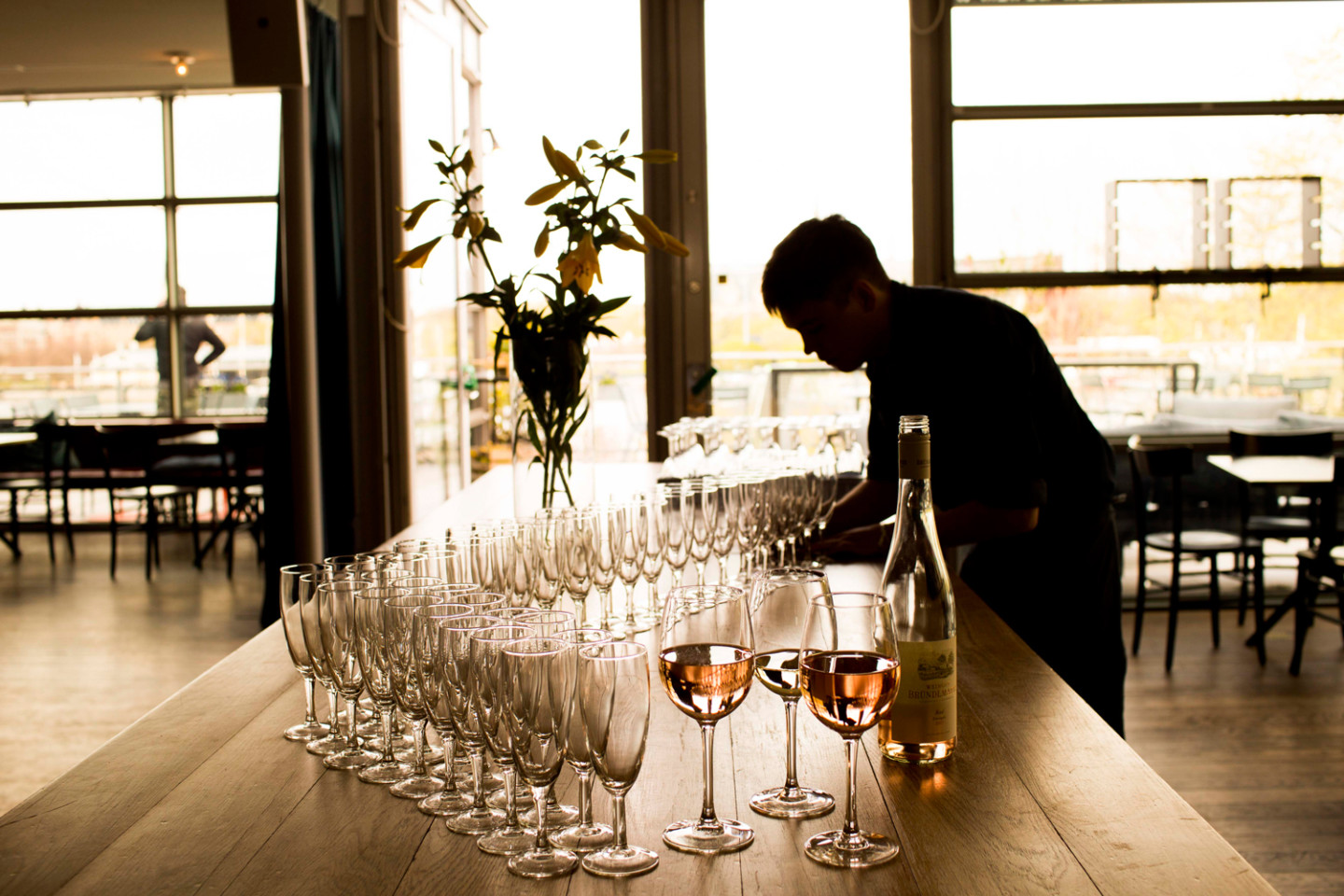 Wine glasses set on table with white tablecloth.